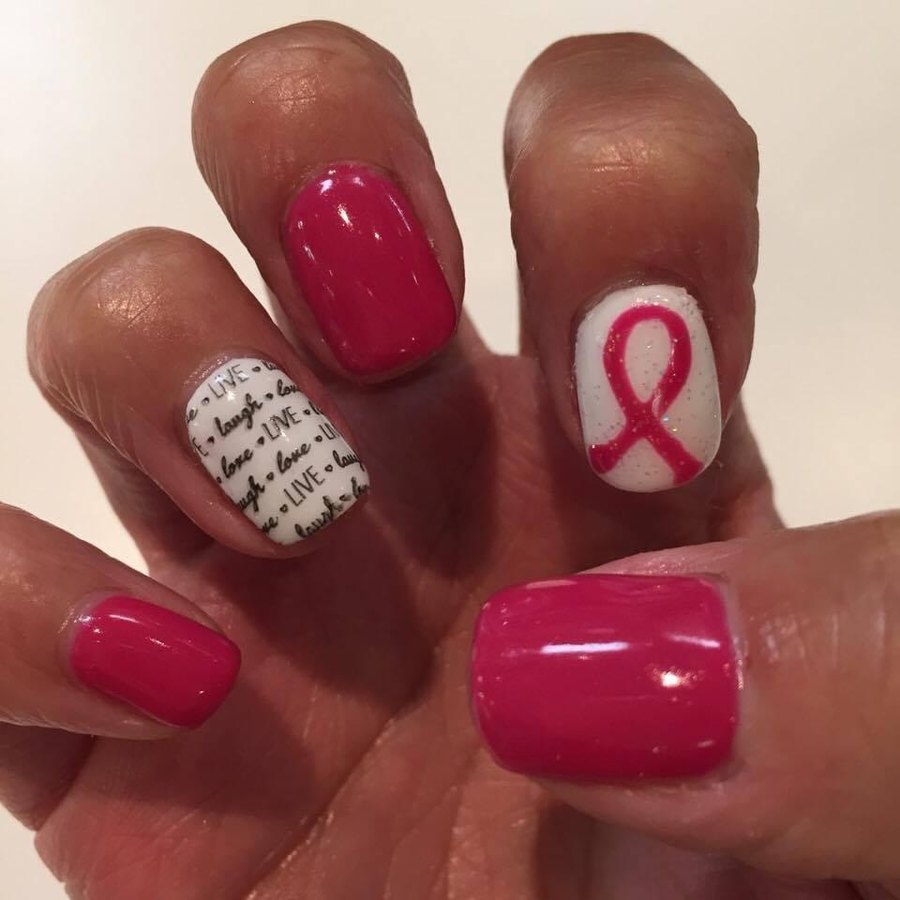 Deep pink gel manicure with pink ribbon accent nails at The Shoppes At North Park nail salon OKC