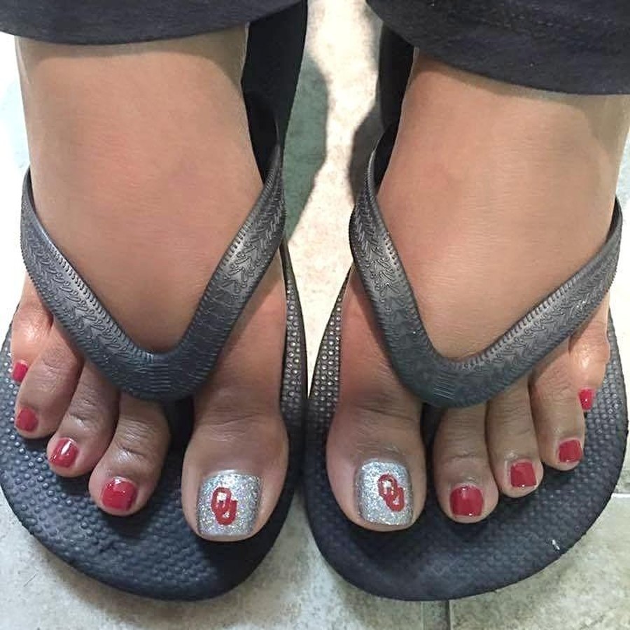 Red spa pedicure with white polka dot accent toe at Designers Plus in Oklahoma City