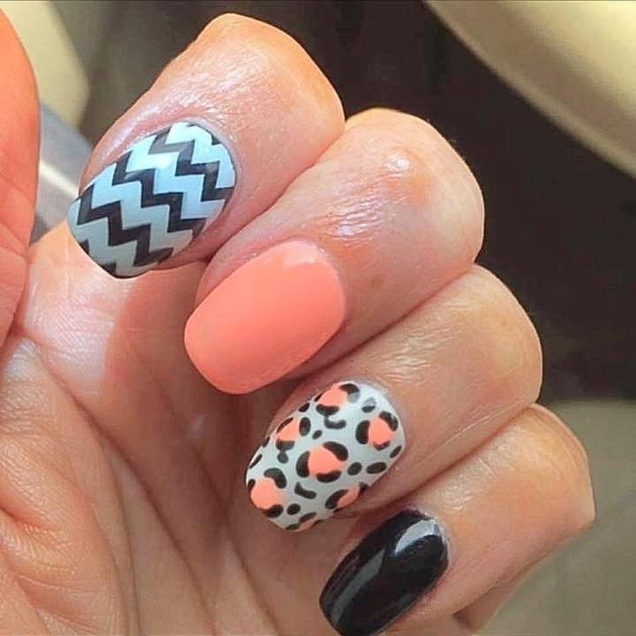 Coral acrylic nails with chevron accent nails by an OKC nail technician