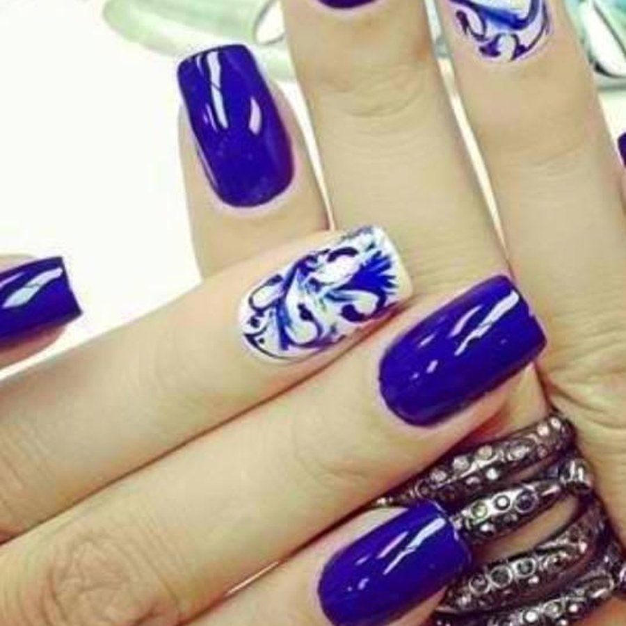 Cobalt blue acrylic nails with white floral accent nails near Nichols Hills